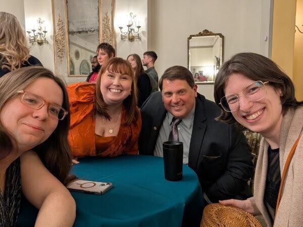 Friends sharing a table and a selfie at a dinner