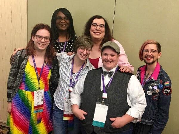 A group of friends smiling together at a conference
